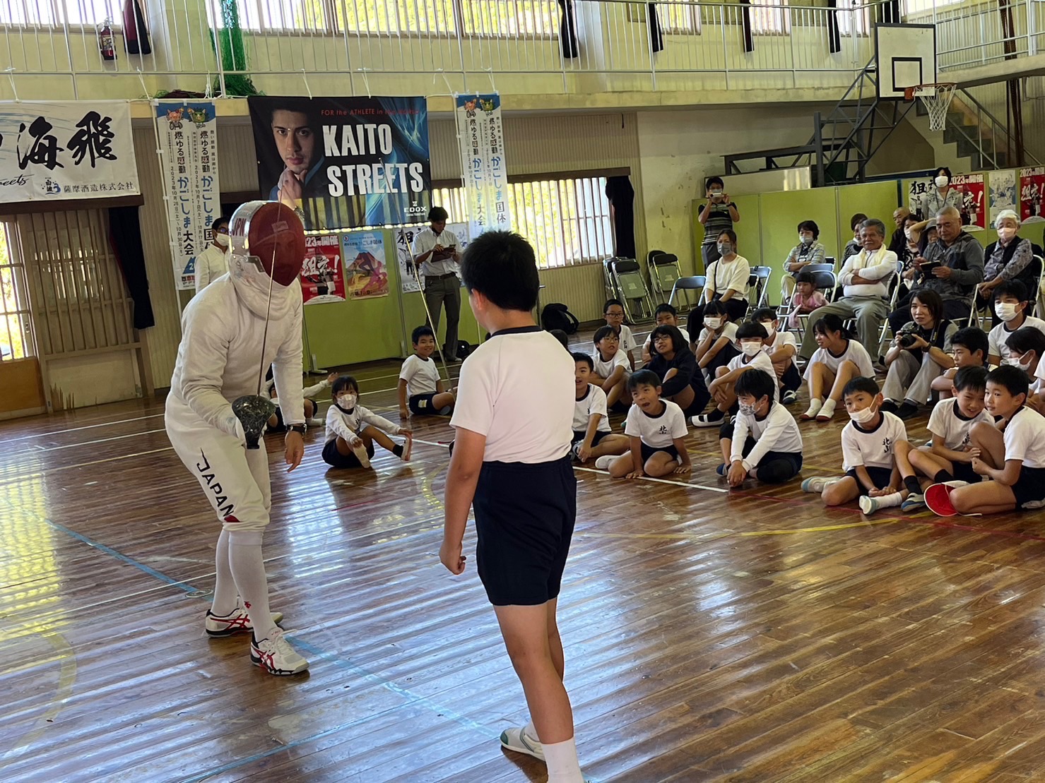 Kaito Streets coaching students at a school gym